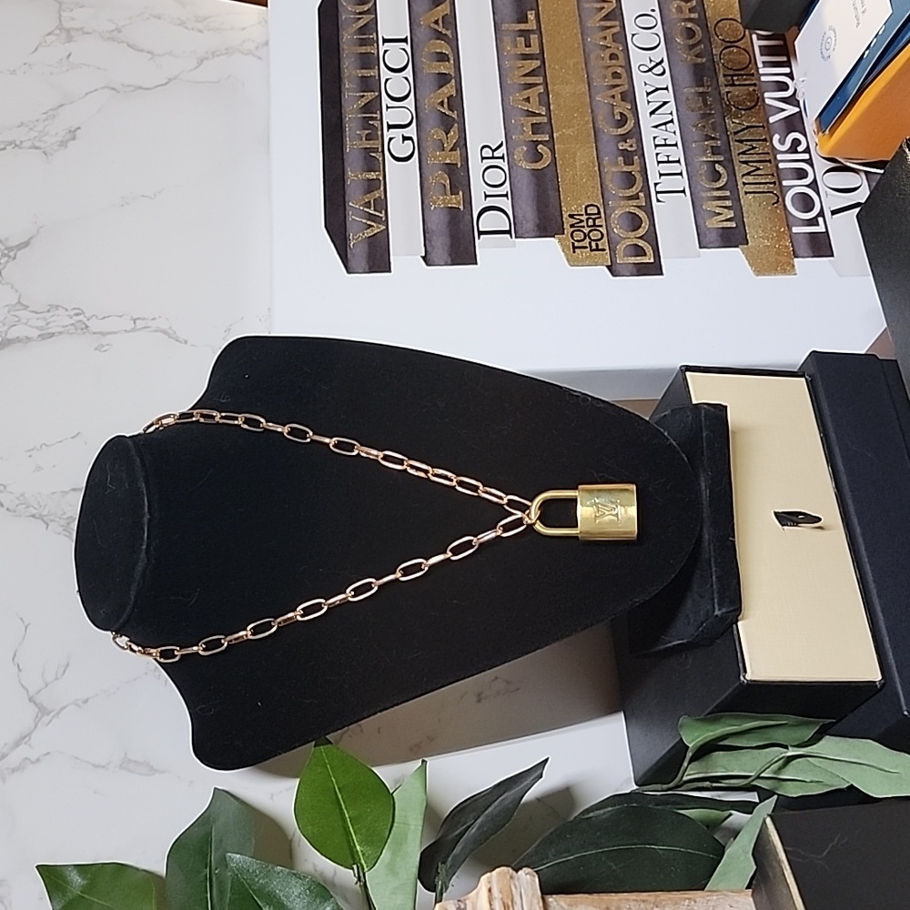 Louis Vuitton lock 🔐 and key 🔐 set on a gold tone hardware chain